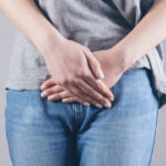 An image of a person wearing a gray shirt with jeans